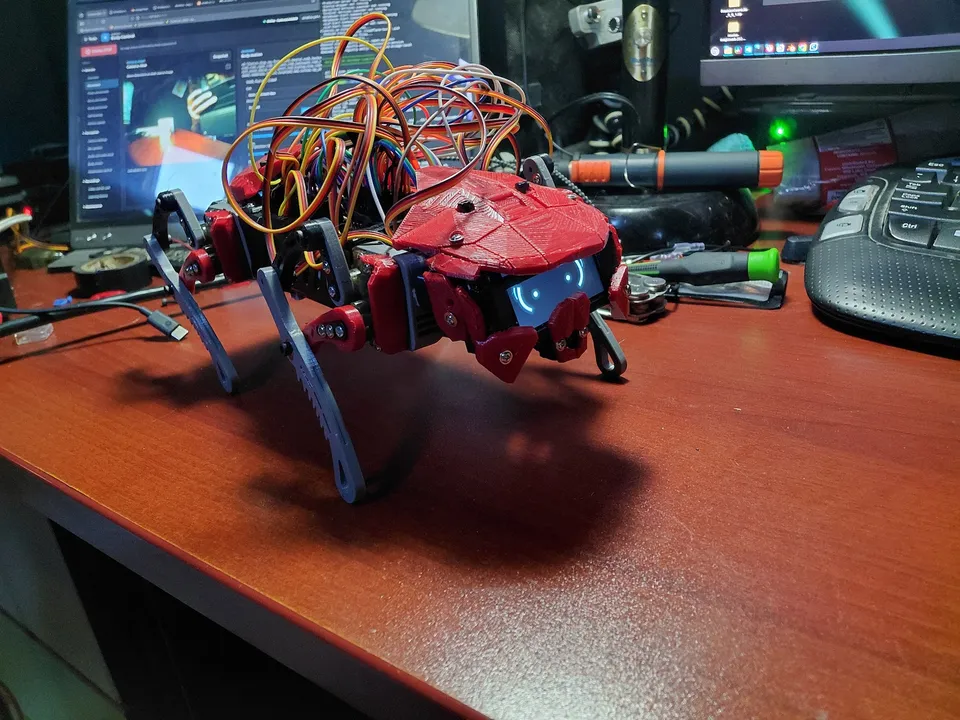 A three-quarter view of the rebuilt body and its four linkage legs on the workbench.