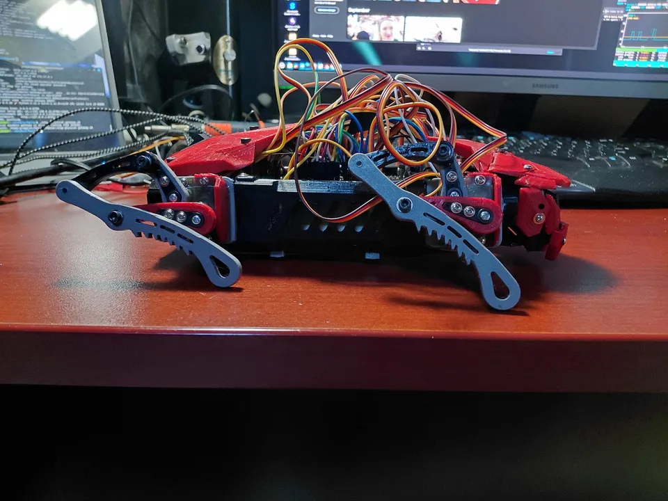 The October 21 prototype in a low stance, showing its side frame, leg mechanisms and new red body pieces.